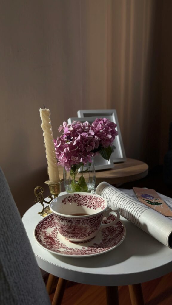 Homeschooling children around a table with books and tea