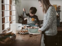 Young child getting dressed independently in a softly lit bedroom during a peaceful homeschool morning routine